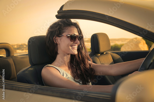 Happy woman driving a car © olly