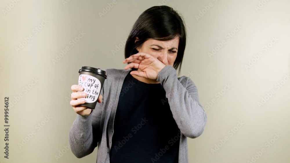 Lovely brunette disgusted by the taste of the beverage Lovely brunette disgusted by the taste of the beverage