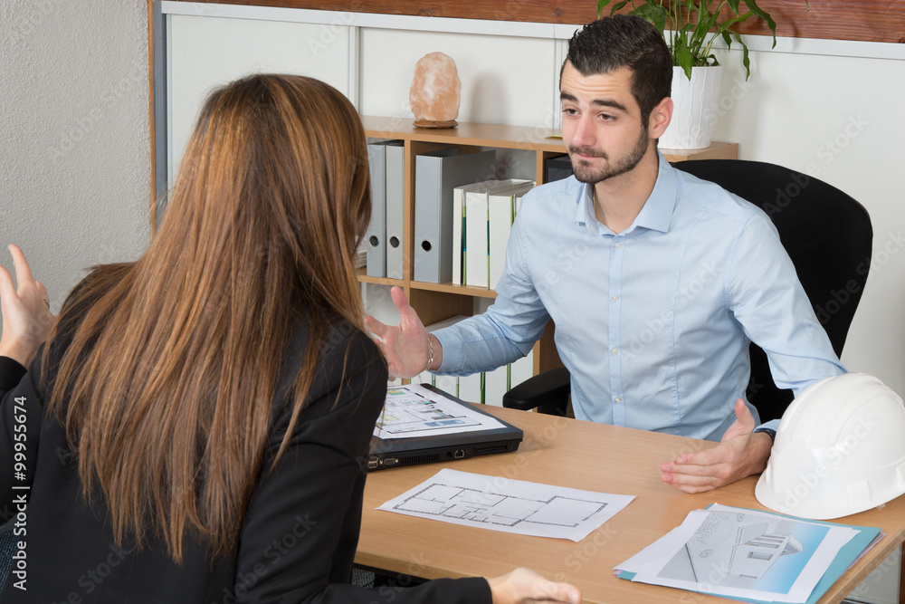 Professional business man and woman sitting in the office Professional business man and woman sitting in the office