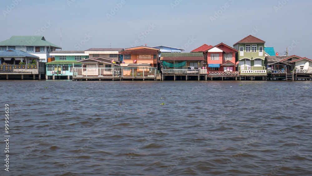 Traditional stilt houses on Chao Phraya's riverbank Traditional stilt houses on Chao Phraya's riverbank
