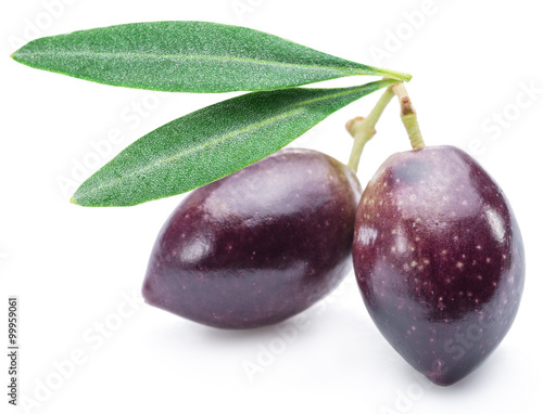 Two fresh olives with leaves on the white background.