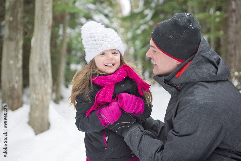 Father and daughter outdoor in the winter forest