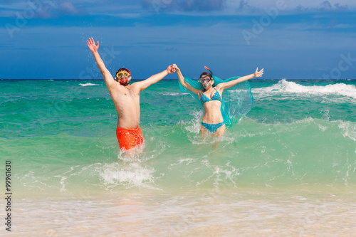 Happy couple having fun on the beach of a tropical island Summer