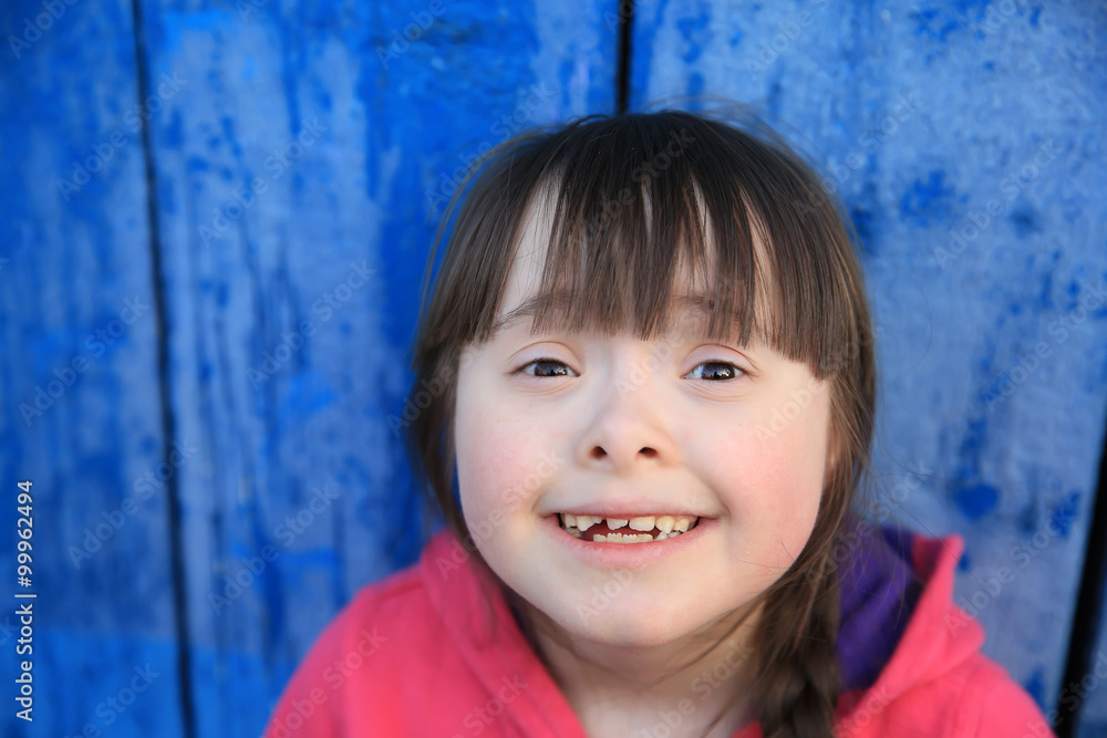 Young girl smiling on background of the blue wall. Young girl smiling on background of the blue wall.