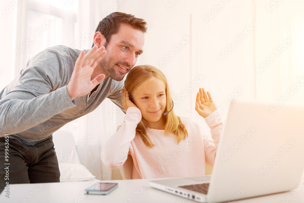 Obraz premium Father and his blond daughter videocalling