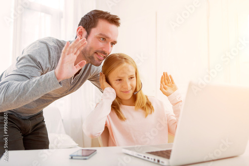 Father and his blond daughter videocalling