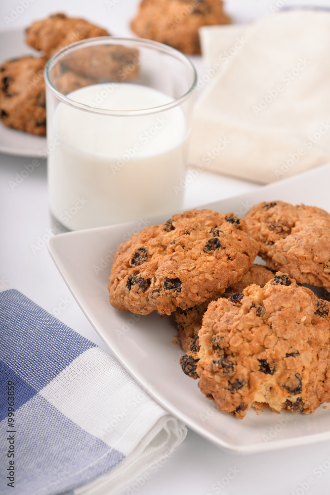 Still life of oatmeal raisin cookies and milk glass Still life of oatmeal raisin cookies and milk glass