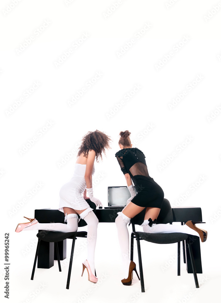 Obraz premium sexy two women at office with a laptop