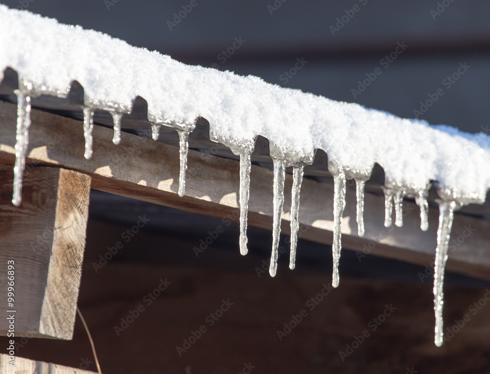 Long and dangerous icicles on a house roof Long and dangerous icicles on a house roof