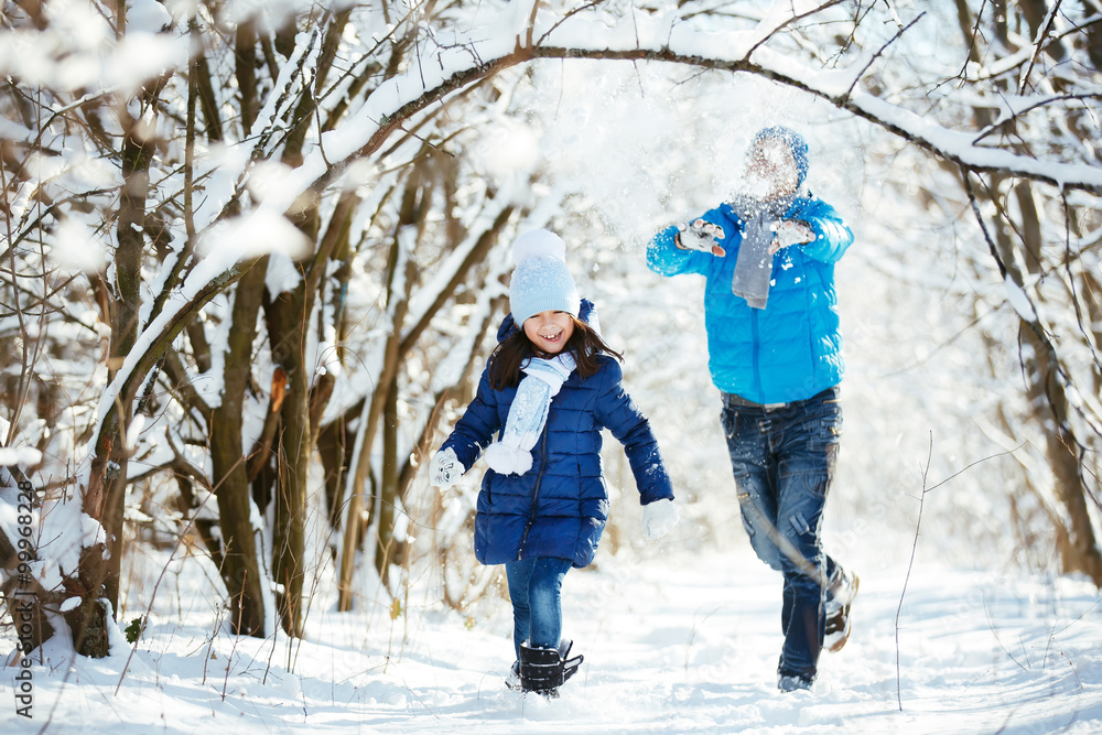 father and daughter playing in the snow in winter father and daughter playing in the snow in winter