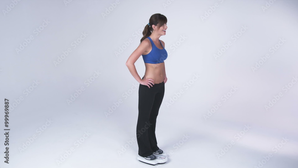 Woman steps onto scale and is excited Woman steps onto scale and is excited