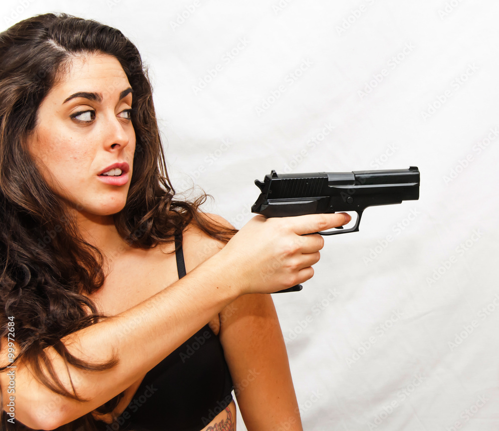 Portrait of Beautiful Young Woman wielding a gun Portrait of Beautiful Young Woman wielding a gun