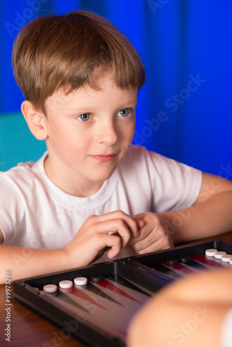 boy playing a board game called Backgammon