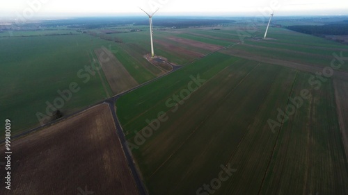 Aerial view of wind turbines in green countryside photo