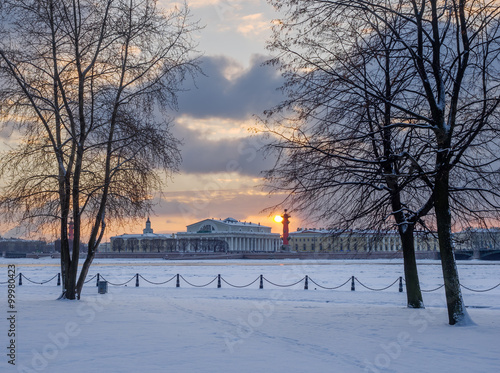 Saint Petersburg in winter. Sunset on the background architecture Spit of Vasilyevsky Island view from Spit of Hare Island across the river Neva