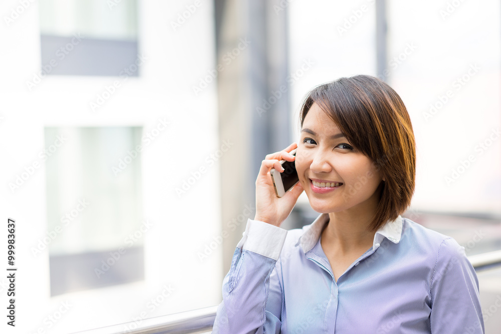 Asian businesswoman using mobile phone at office Asian businesswoman using mobile phone at office