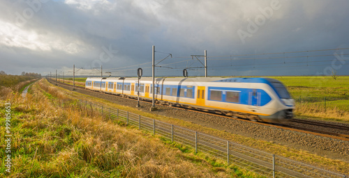 Electric train in sunny deteriorating weather 