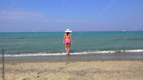 Woman walking to water in bikinni  photo