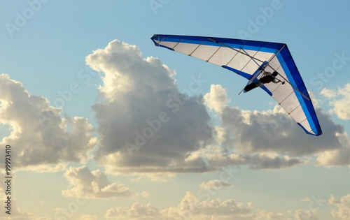 Hang Glider flying in the sky on blue day