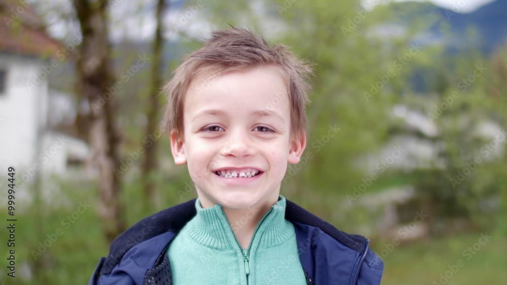 Simpathic kid smiling in camera Simpathic kid smiling in camera