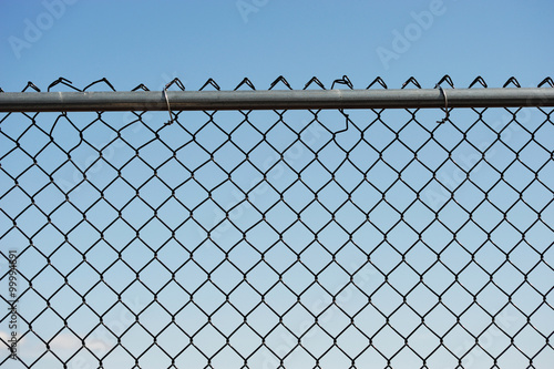 iron chainlink fence against sky photo