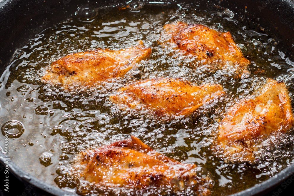 Chicken frying in a pan Chicken frying in a pan