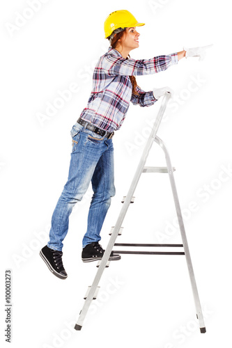 Young worker stands on the stairs looks straight ahead