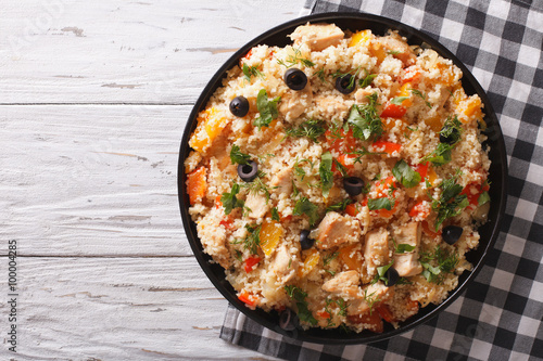 couscous with chicken, olives and vegetables. Horizontal top view
