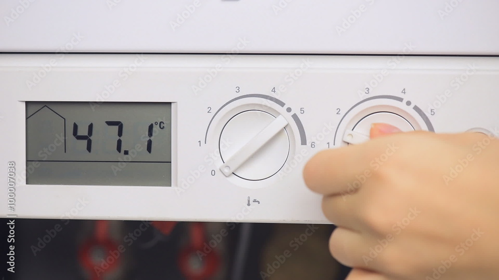 Female hand includes house heating boiler Female hand includes house heating boiler