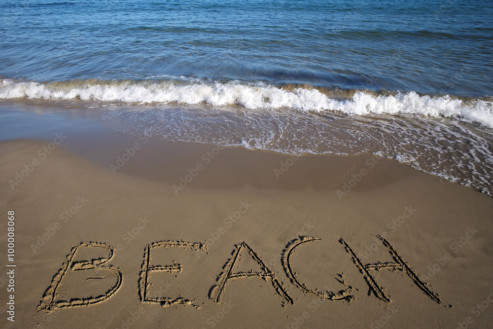 Fototapeta premium Beach written on wet sand