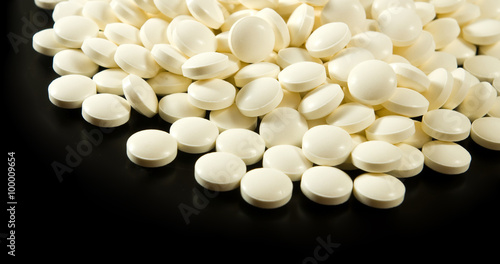  pills on a black background closeup