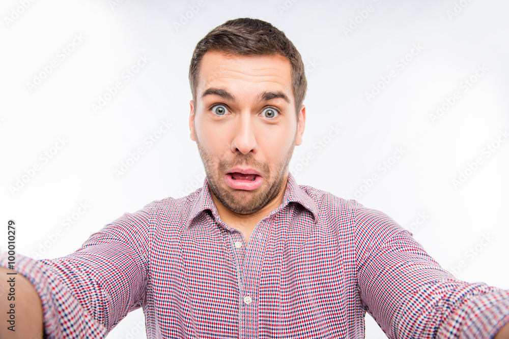 Pretty man making comic selfie with grimace Pretty man making comic selfie with grimace