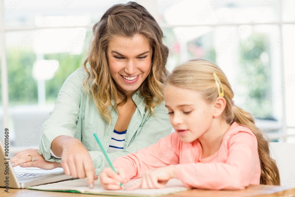 Mother checking daughter's homework Mother checking daughter's homework