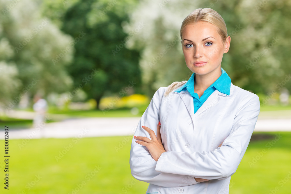 Beautiful smiling doctor woman in medical gown Beautiful smiling doctor woman in medical gown