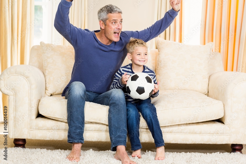 Father and son exulting on the sofa Father and son exulting on the sofa