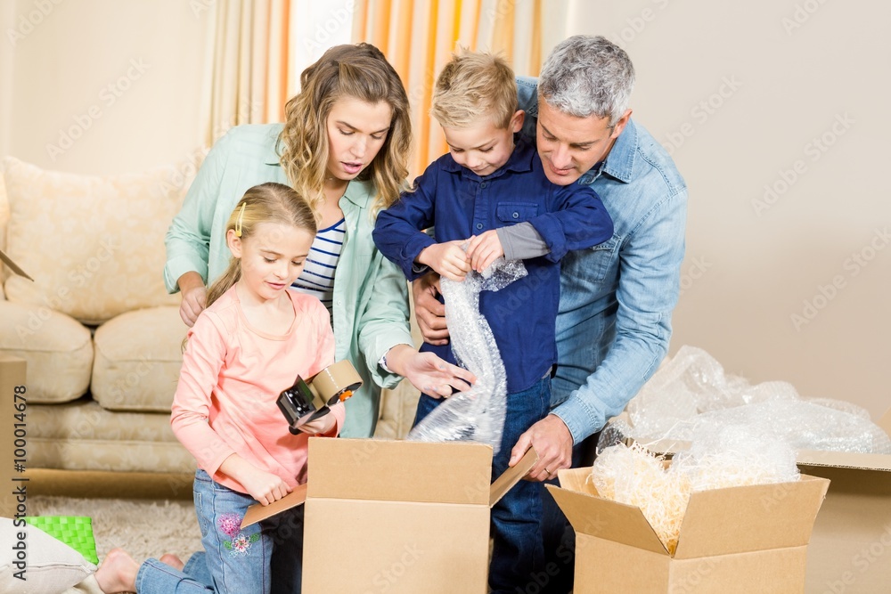 Portrait of happy family opening boxes Portrait of happy family opening boxes