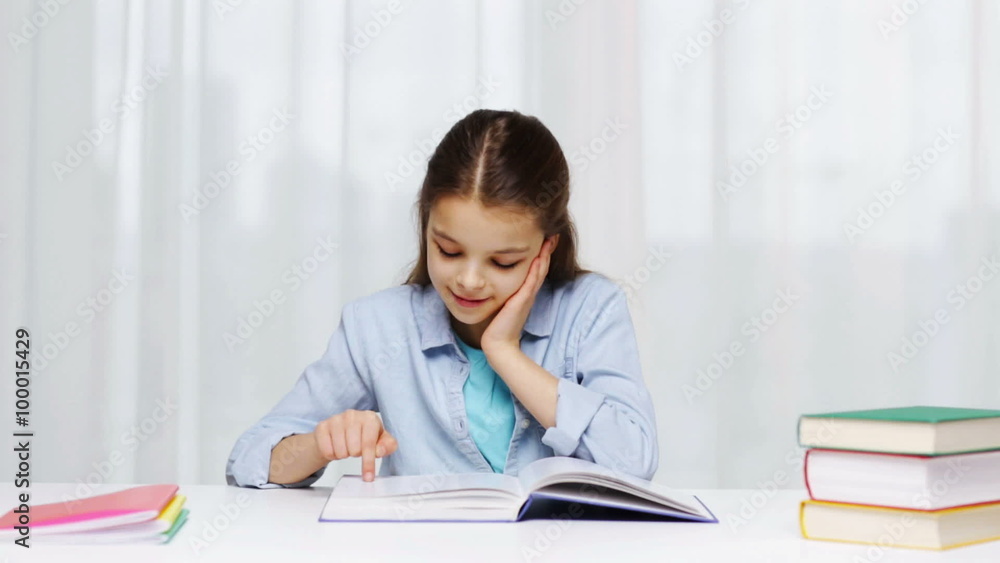 happy school girl reading book or textbook at home happy school girl reading book or textbook at home