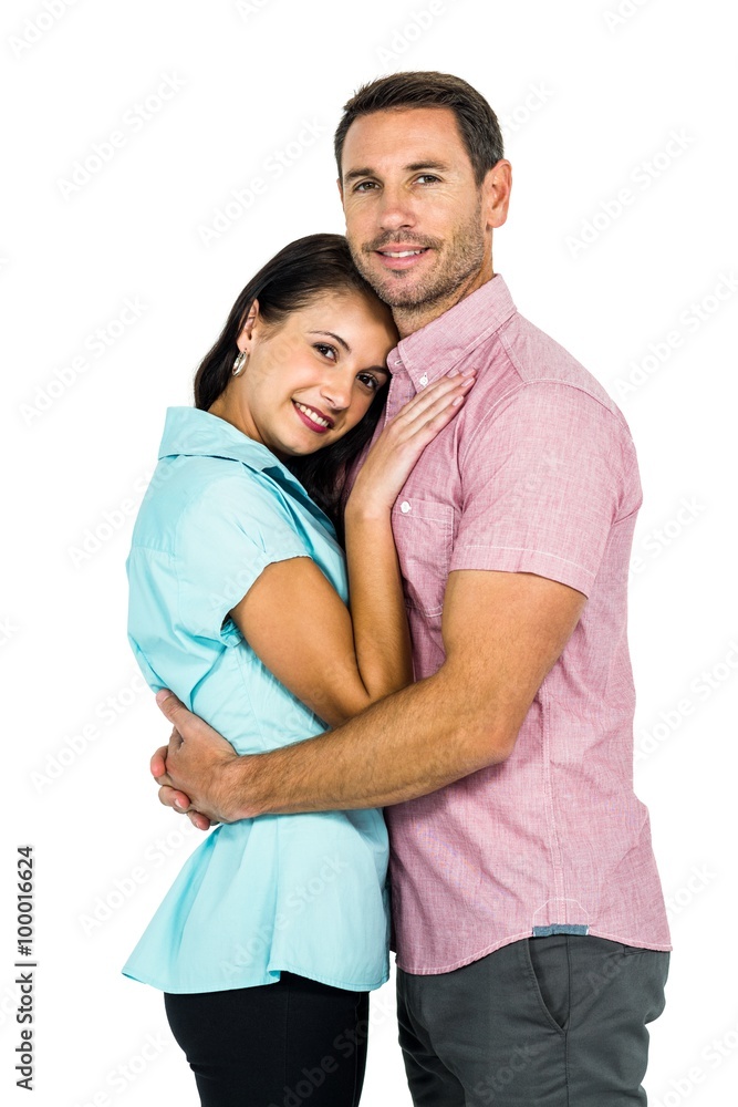 Smiling couple hugging and looking at camera Smiling couple hugging and looking at camera