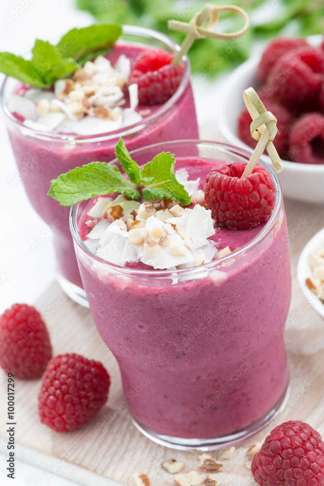 fresh berry smoothies with nuts on white board, vertical fresh berry smoothies with nuts on white board, vertical