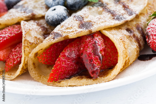 crepes with fresh berries and chocolate sauce, closeup