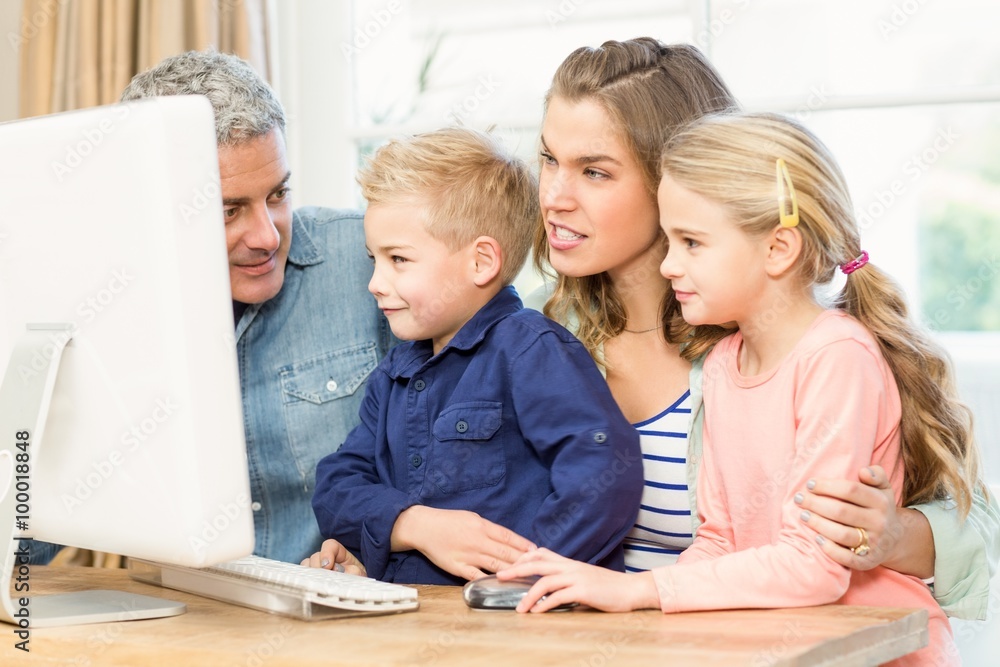 Happy family using the computer Happy family using the computer