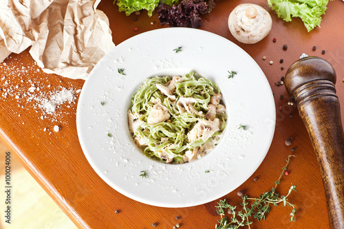 Italian pasta with sauce and parmesan cheese, served on a white plate photo