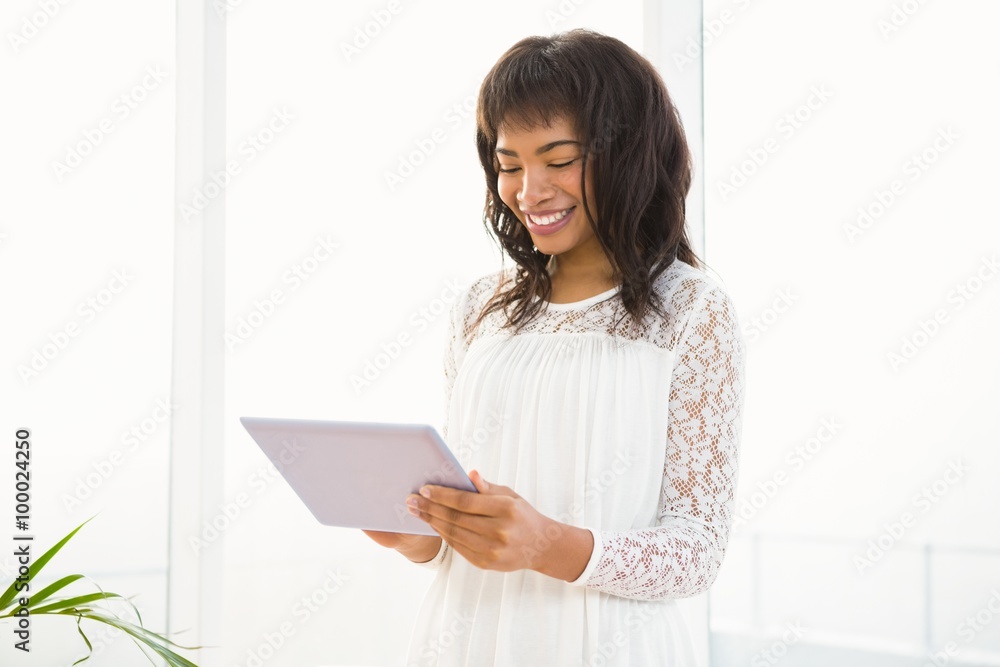 Smiling woman using her tablet in living room Smiling woman using her tablet in living room