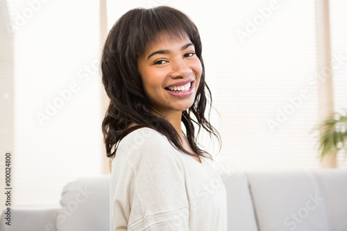 Pretty woman smiling on couch Free Download Pretty woman smiling on couch - GFXLoad
