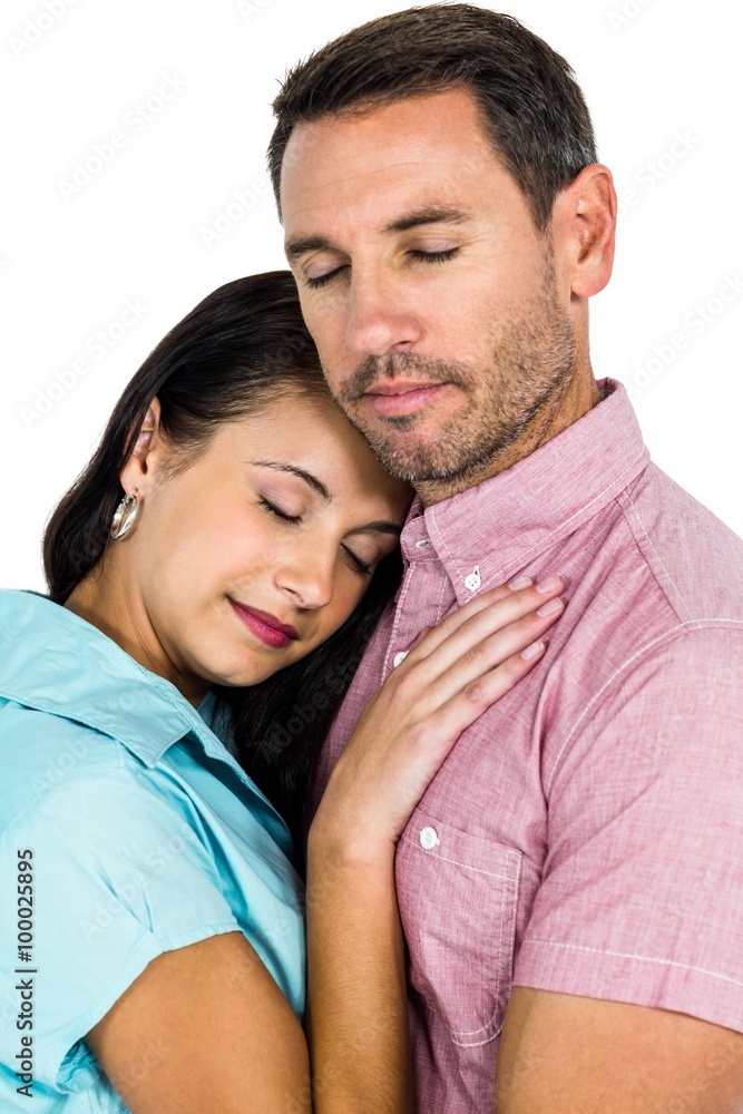 Peaceful couple hugging with eyes closed Peaceful couple hugging with eyes closed