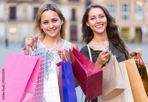 girls carrying bags with purchases