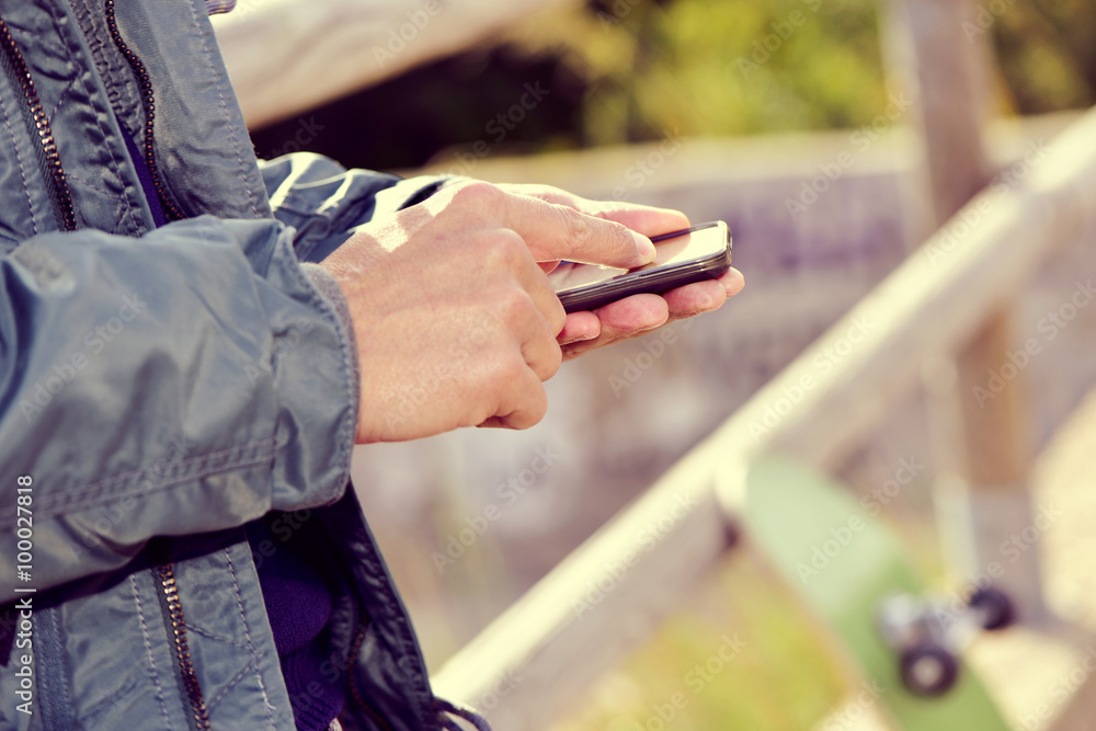 young man using a smartphone outdoors