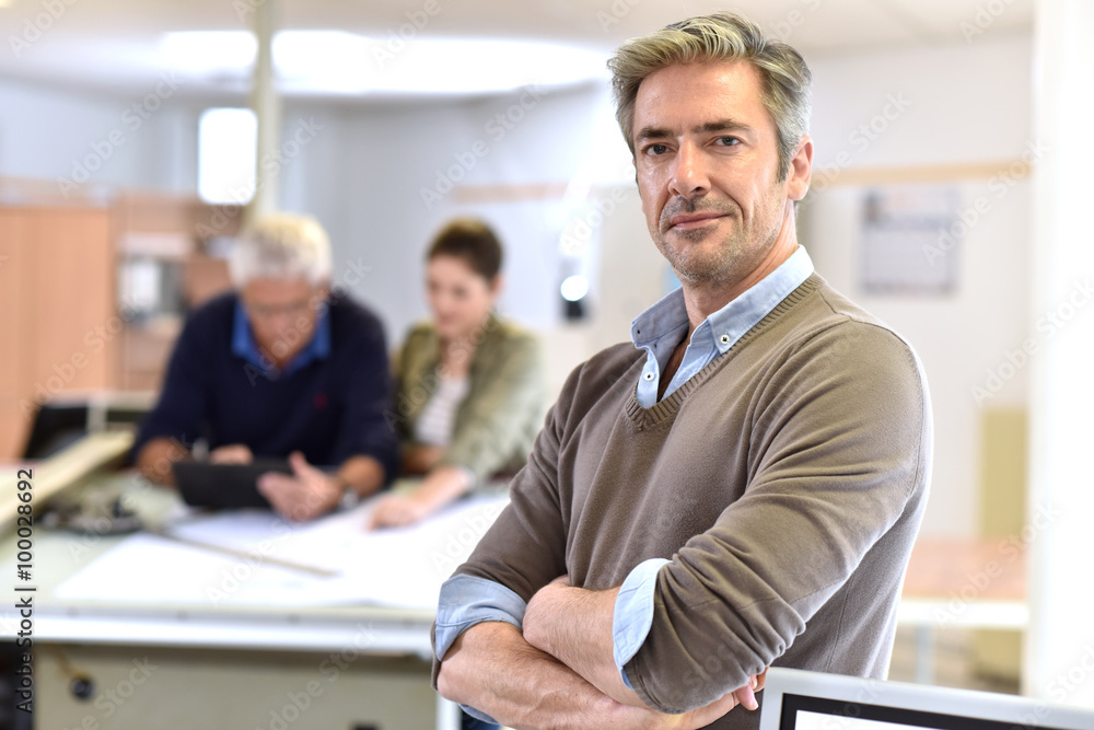 Businessman standing in design office Businessman standing in design office