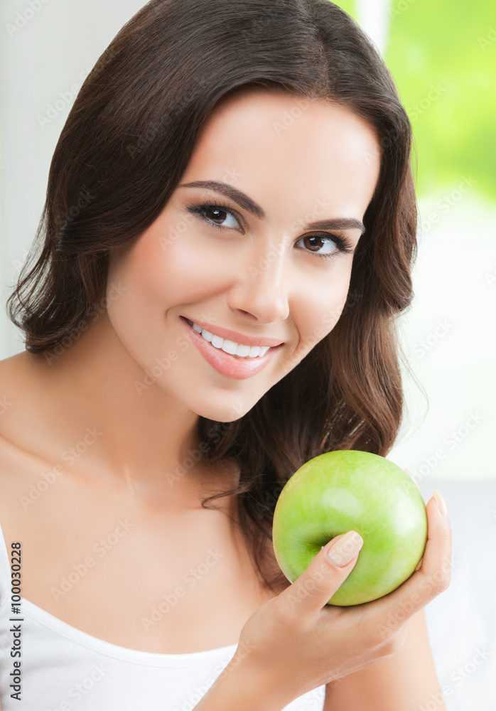 Young happy smiling woman with green apple, indoors Young happy smiling woman with green apple, indoors