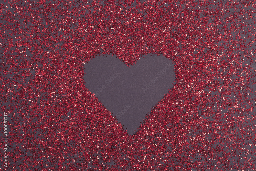 red glitter heart shape on dark ground red glitter heart shape on dark ground